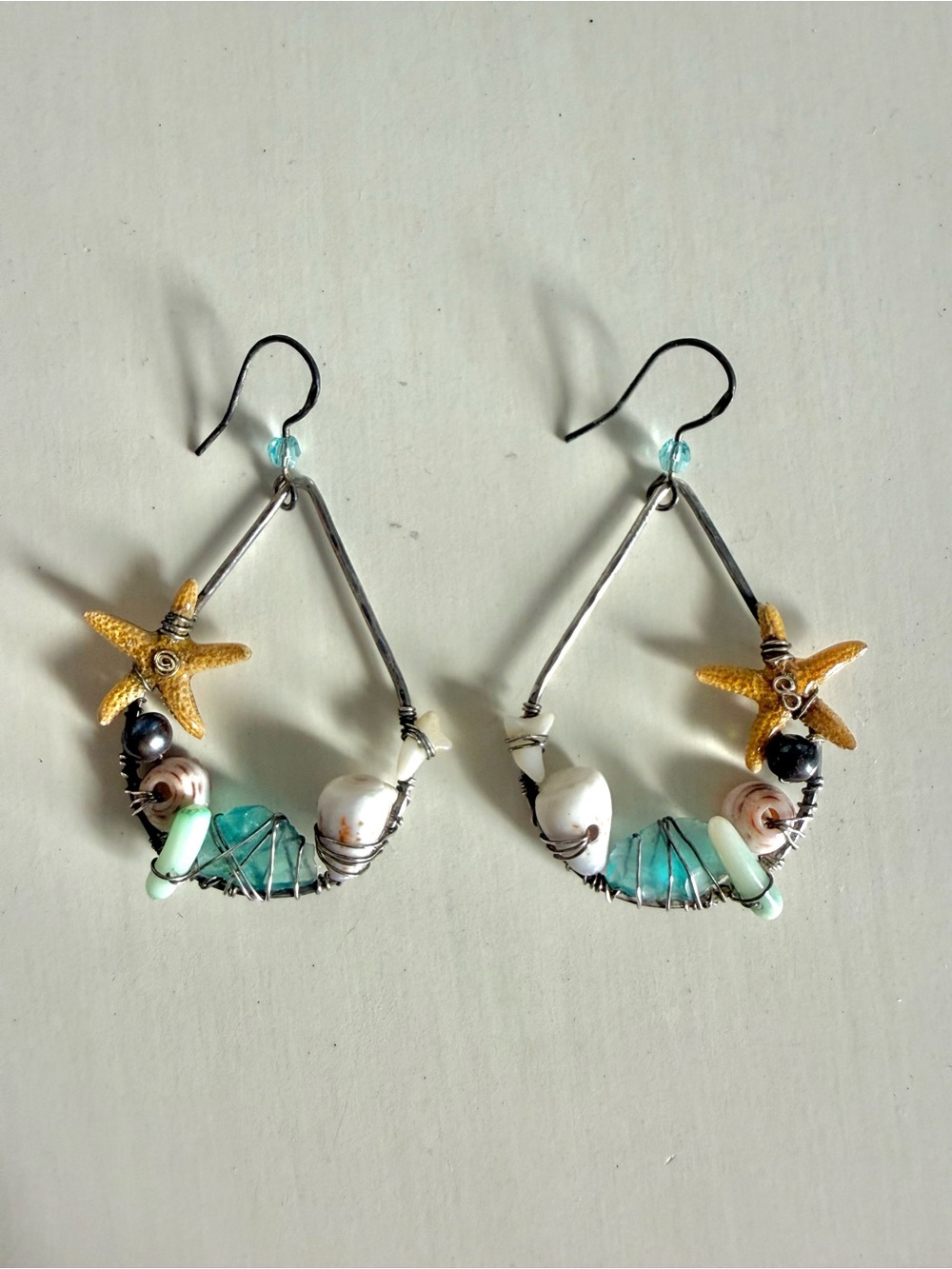 Handmade beachy silver hoop earrings with starfish and shells